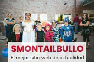children standing while holding Jack 'o lantern and wearing costume