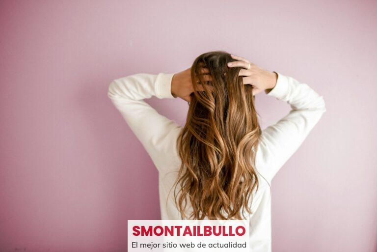 woman in white long-sleeved shirt standing in front of pink wall